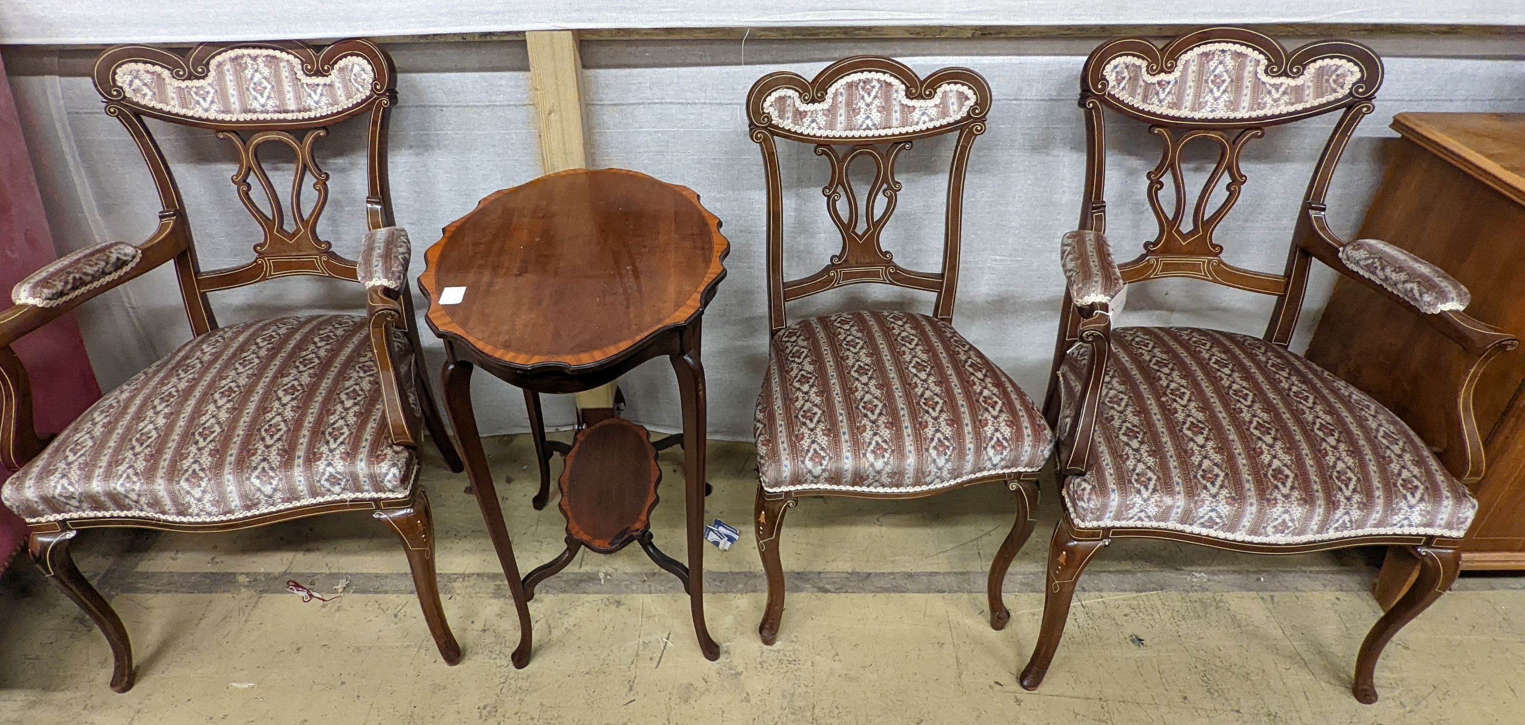 Three late Victorian bone inlaid mahogany chairs, two with arms, together with an Edwardian oval satinwood banded occasional table.